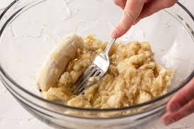 Mashing bananas in a bowl