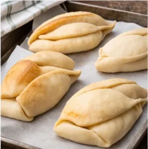 Coco dough rising on a baking pan