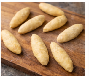 8 pieces of Jamaican festival dumplings on a cutting board